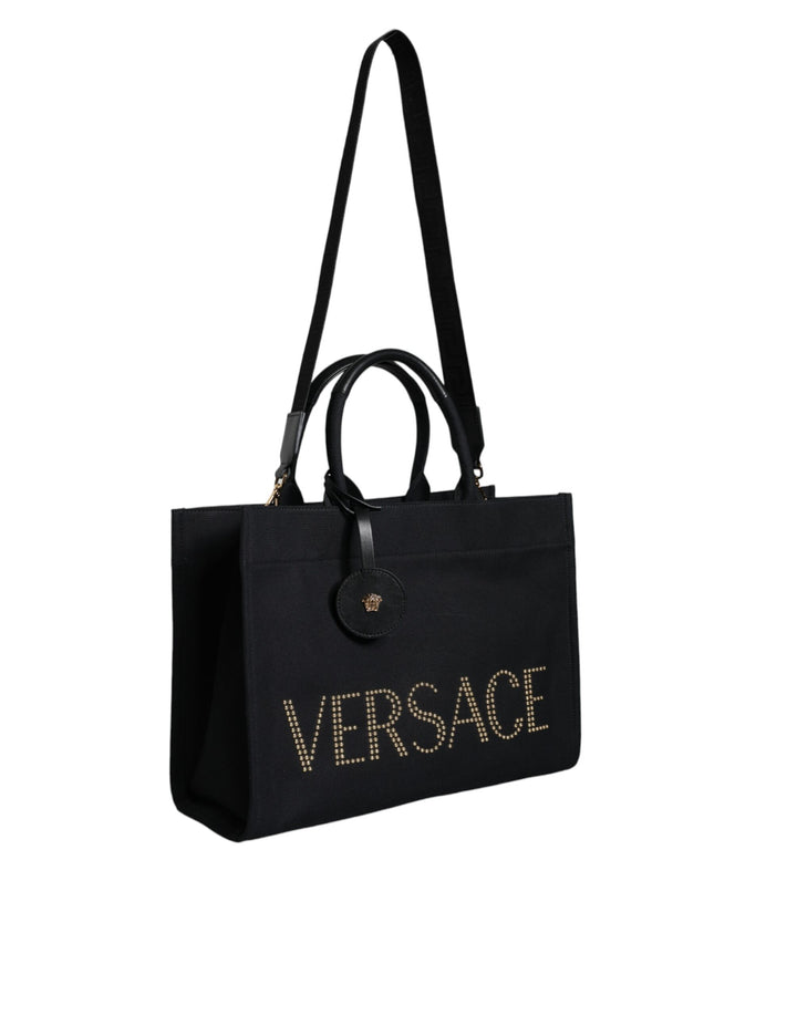 Bolso tote cruzado Versace de lona y cuero con asa superior en color negro y logotipo