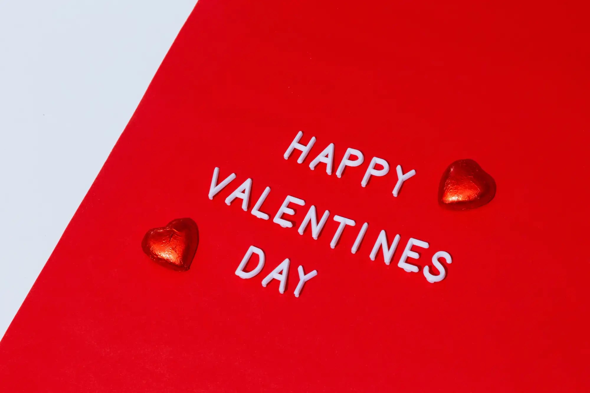 Red card with 'Happy Valentine's Day' text and heart decorations on a light gray background